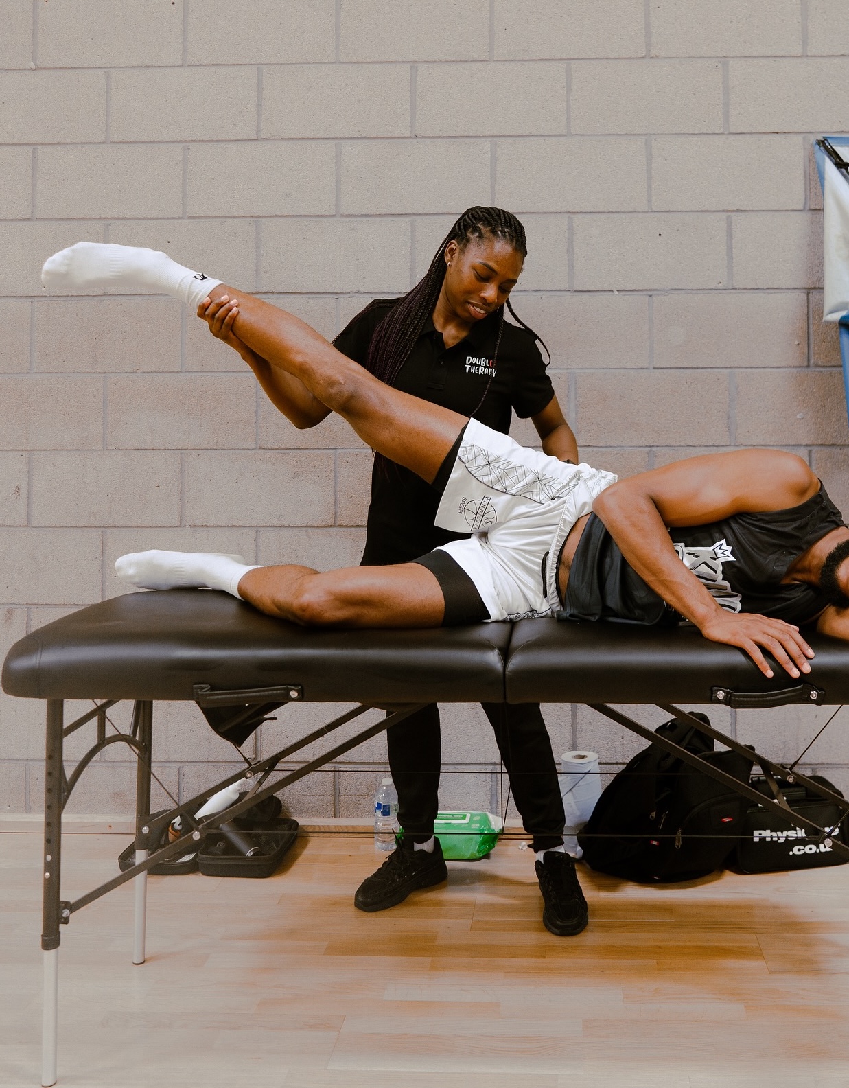 DoubleE Therapy sports therapist treating an athlete